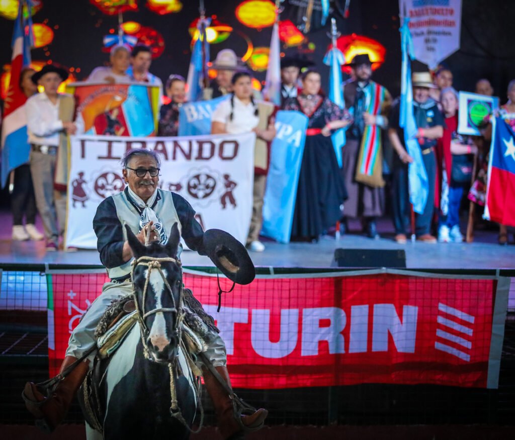 Elder performer entering community stage event during cultural celebration