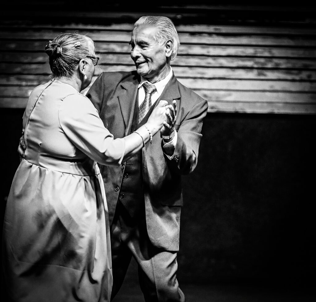 Older couple dancing together during community gathering
