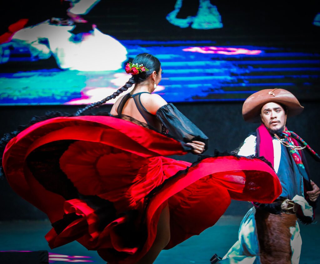 Cultural dance performance with expressive movement and flowing red textile