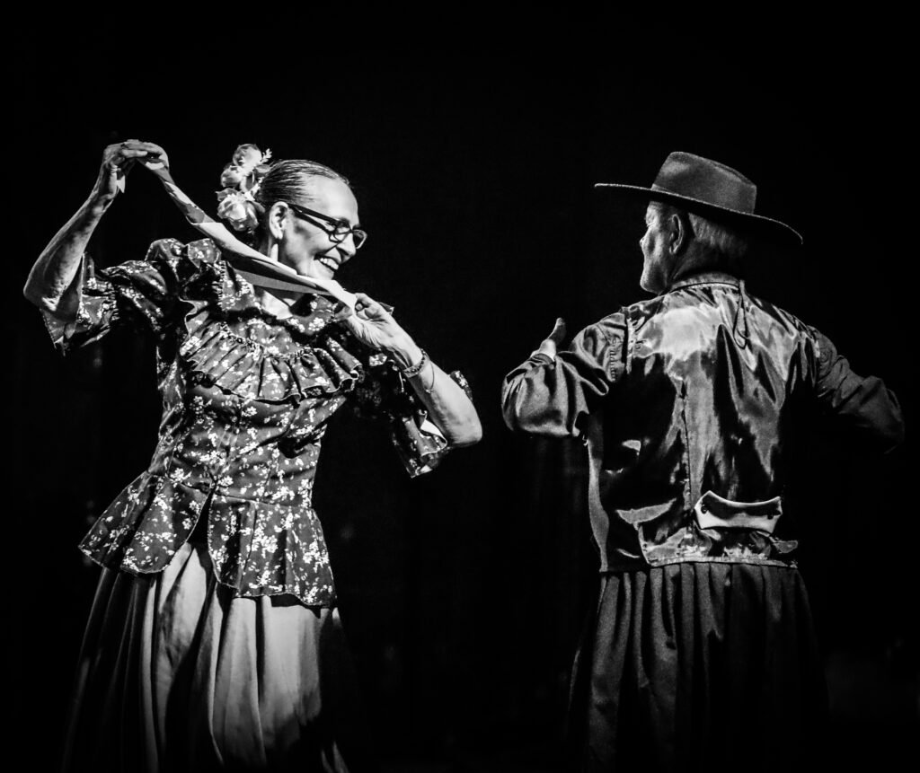 Two performers dancing together on stage