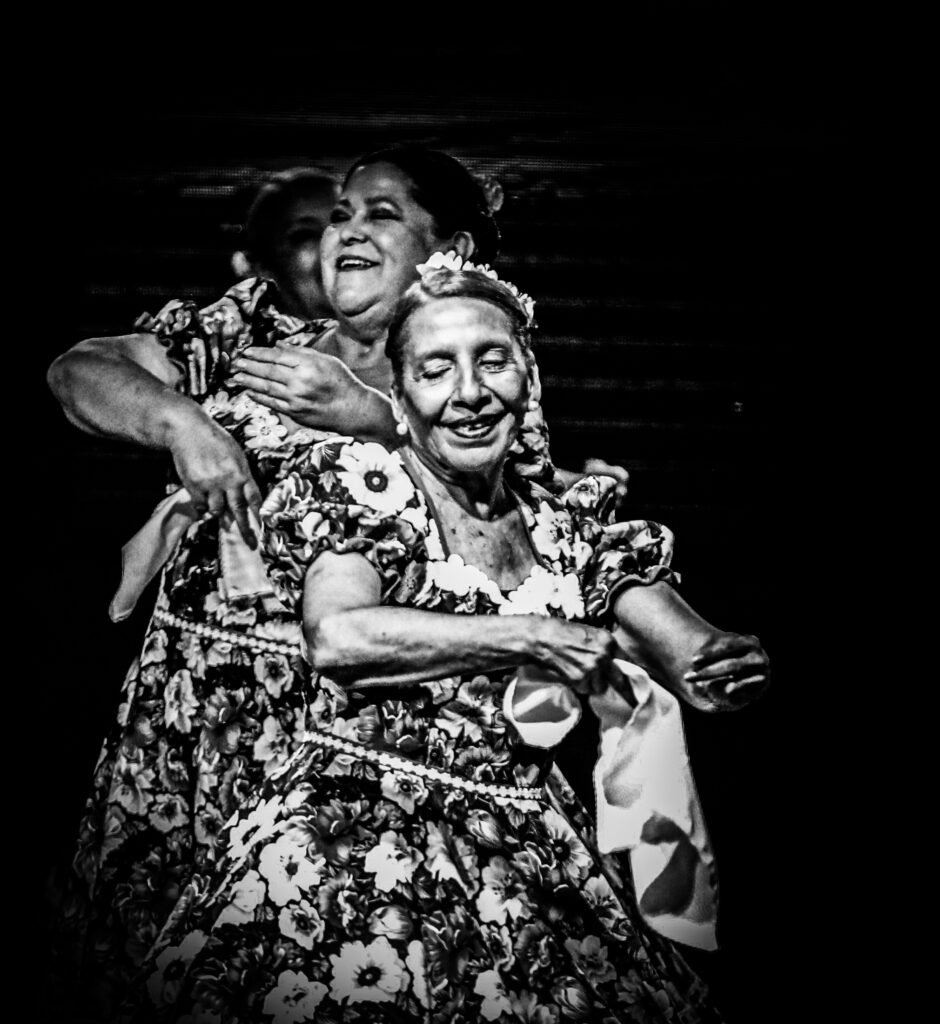 Dancers embracing during energetic communal dance